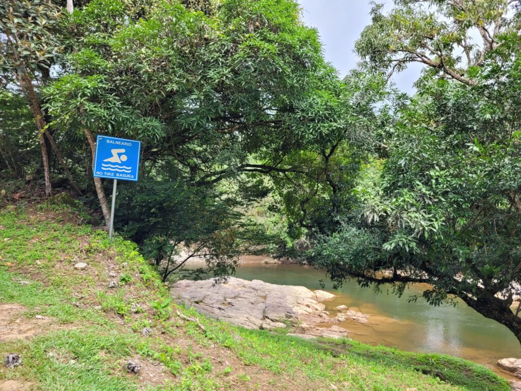 A sign showing its allowed to have a swim in the river 