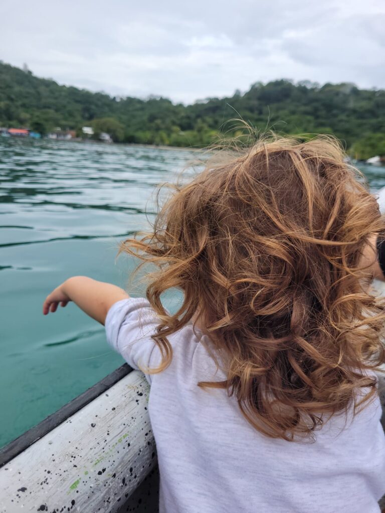 Toddler in a boat enjoying the fresh air 