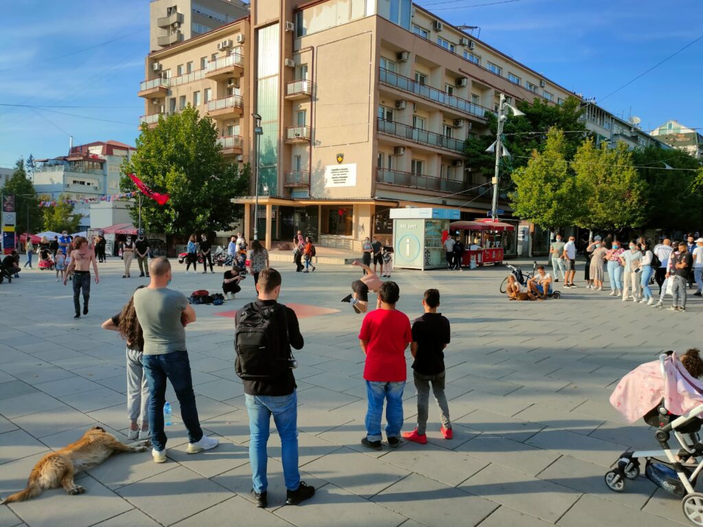 A group of people standing around a street show